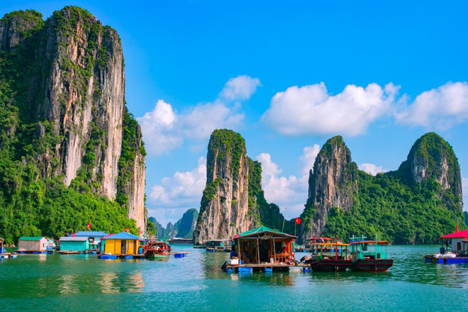 Floating fishing village and rock island in Halong Bay